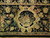 Ivory acanthus scroll cartouche framing a flower basket in the wide black outer border