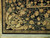 Corner detail showing ivory fringe, guard border and carved scrollwork of this 8x10 Oriental rug