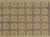 Measuring 8'8" x 11'8", the Indian wool rug shows ivory vine scrollwork linking golden roundels