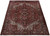 Full 8x11 Persian Heriz rug angled view showing navy rosette border and brick red field