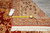 Genuine hand woven Oriental rug tag with tape measure beside the beige border and fringe