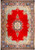 Red open field Persian Sarouk rug with navy floral medallion and light blue corner spandrels