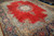 Angled view of the large 10x13 Persian rug highlighting light blue spandrels and navy border