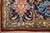 Corner detail showing ivory guard border, dense hand-knotted wool pile and white cotton fringe