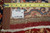 Reverse of the hand-knotted rug with tape measure and dealer tag over cotton foundation
