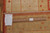 Back of the 9x12 rug with handmade tag, ruler scale and cotton fringe