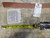Original woven rug tags and tape measure confirming hand-knotted wool construction and authentic Persian origin