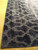 Corner detail showing deep indigo shading and high-low carved texture across the hand-knotted modern rug