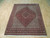 6'7" x 8'2" Persian Bijar rug displayed on light oak flooring showing cream borders and red center