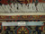 Twelve inch ruler laid across the border and fringe beside an authentic hand-knotted label