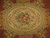Close-up of ivory oval medallion with rose bouquet, acanthus scrolls and pale blue banding