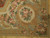 Corner detail showing cream cartouche, pink cabbage roses, gold scrollwork and soft blue ribbon border