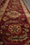 Border detail of the 9x12 Indian rug with rosettes, leafy vines and beige guard stripe