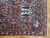 Corner detail showing palmette border, ivory guard stripes and finely knotted wool pile on 9x12 rug