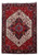 Full overhead view of 7'8" x 10'10" Persian Heriz rug with ivory medallion on red field