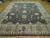 Warm indoor lighting on the 12x15 traditional area rug, dark field and ivory sage border