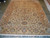 8'11 x 11'10 hand-knotted wool and silk Indian rug laid flat on showroom floor