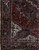 Corner detail of ivory spandrel, navy main border and multiple guard borders on this Heriz rug