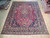 9'10" x 12'5" Persian Kashmar rug shown flat on wood floor in our showroom