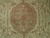 Close-up of camel scalloped medallion with paisley leaves, sage rosettes and small rust flower