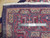 Reverse side with measuring ruler revealing fine hand-knotted wool weave, cotton foundation and ivory fringe