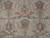 Close-up of sage and rust palmettes on soft beige wool field of semi-antique Oushak rug