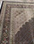 Corner detail showing ivory guard stripes, black floral border and salmon toned fish pattern