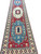 Full view of 4'10" x 19'10" red Kazak runner rug with three blue and ivory medallions