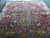 Vintage 1970s Kashmar rug seen from one end, medallion and crimson palmette border visible