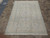 6'6" x 9'6" hand-knotted Tabriz rug viewed lengthwise, cream field framed by blue floral border