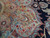 Close-up of sky blue and camel medallion petals with red blossoms and fine wool knotting