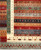 Corner detail of the ivory border, sage green guard stripe and red animal-filled bands, hand-knotted wool
