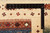 Ruler laid on the ivory border showing fine knot density and hand-spun Ghazni wool pile
