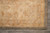Corner of the 9'9" x 13'9" Chobi Peshawar rug showing border resolution, grey selvedge and cream fringe