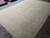 8'7" x 11'7" hand-knotted wool rug from Peshawar shown at an angle in sand and taupe