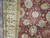 Close view of mauve field, gold vine lattice and palmettes beside the ivory main border