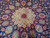 Detailed macro of the Sheik Safi medallion showing red rosette and fine wool knotting