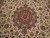 8x10 Persian Tabriz rug detail of maroon and camel medallion on ivory floral field