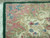 Close-up of pink guard stripe with blue cornflowers beside the dark green outer selvage