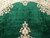 Deep emerald green open field with pile sheen variation and cream and pink rose sprays