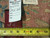 Back of the rug with woven mill label, hand written tag 6349 and tape measure