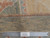 Back of the 11x14 Oushak rug with ruler showing knot density and authentic handmade tag