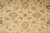 Close detail of light blue and gold palmettes and curling leaves on the beige wool field