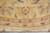 Main border palmette, peach guard stripe and ivory fringe along the circular edge of the rug