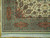 Corner detail showing green main border, cartouche palmettes, ivory guard stripes and cotton fringe