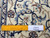 Ruler laid across ivory border showing fine knot density and hand-knotted wool and silk weave