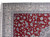 Corner detail of this 9x13 Nain rug showing ivory border, blue vines and white fringe