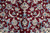 Detail of burgundy field with blue palmettes, cream lotus blossoms and thin silk outlined vines