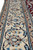 Ivory main border close-up with navy vine tracery, brown stems and pale blue rosettes