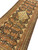 Angled length view down the indigo field, ivory center medallion and rust bordered tribal panels